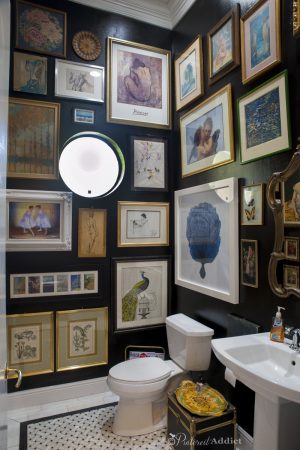 Guest Bathroom After - black walls, marble floors and an artwork gallery.
